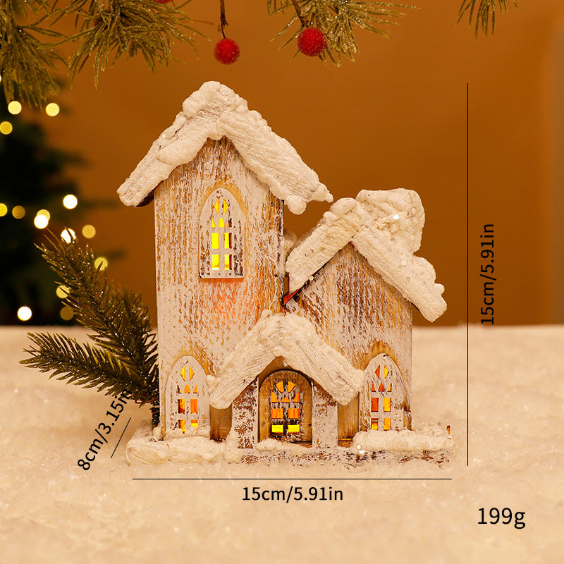 Beleuchtetes Weihnachts-Holzhaus mit Schneelandschaft