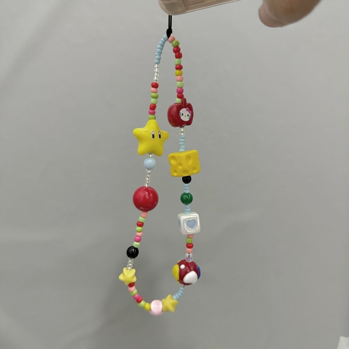 Spielerischer Perlen Charm Handyhalter Brehn