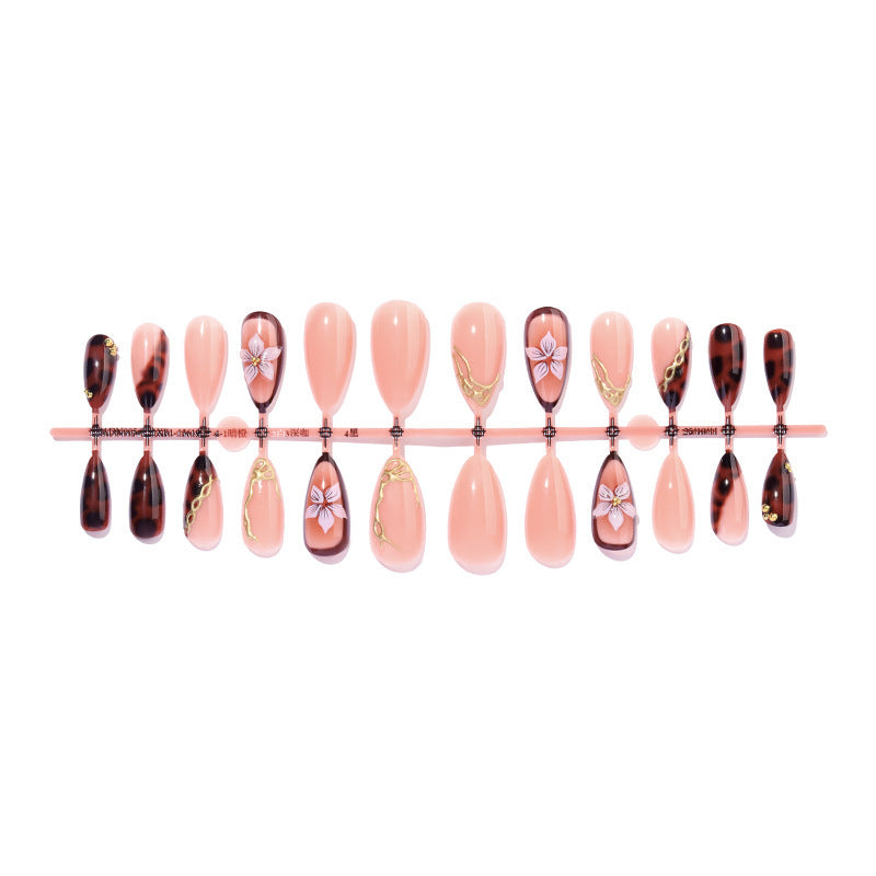Kunstnagelset mit eleganten floralem Dekor und Glitzerelementen Brehn