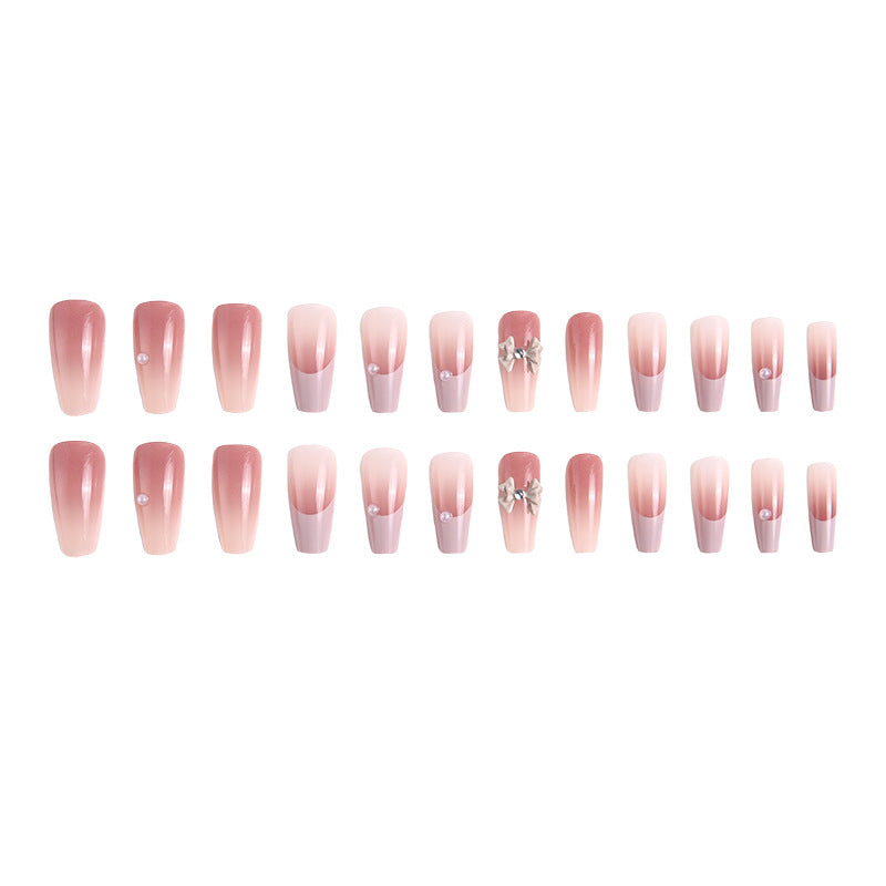 Kunstnagelset mit elegantem Ombre-Design und filigranen Schleifenverzierungen Brehn