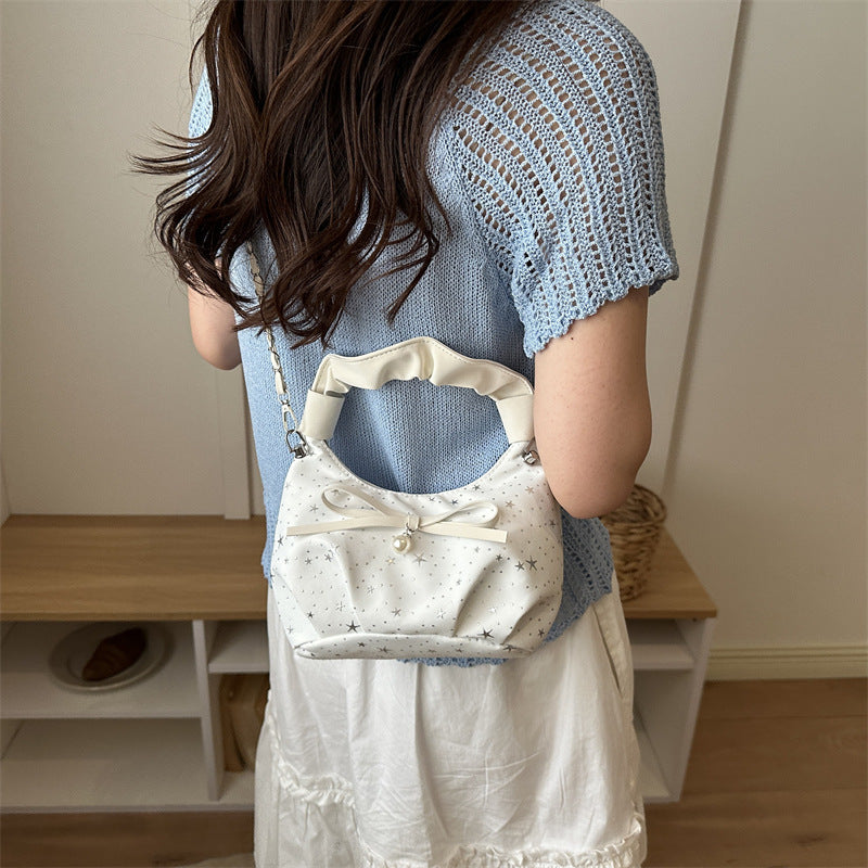 Elegante Handtasche mit Schleifendetail und Sternenprint