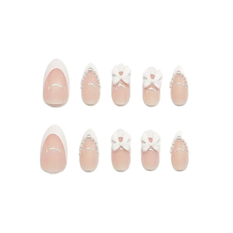 Künstlerisches Press-On-Nageldesign mit Schleifenakzenten Brehn