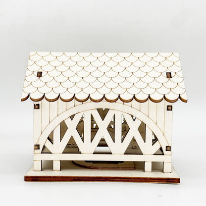Beleuchtetes Holzhaus mit Brücke