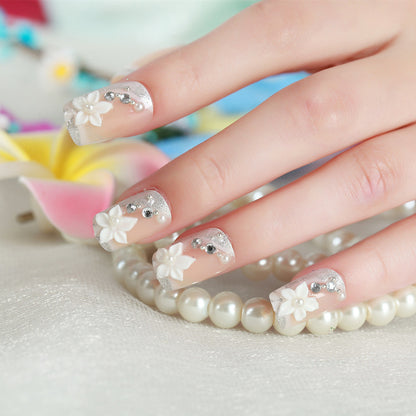 Florales Design Press-On Nail Set mit Strass-Akzenten