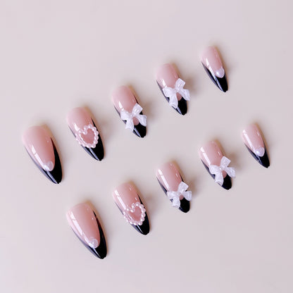 Glamouröse Kunstnagelspitzen mit 3D Schleifen und Herzverzierungen Brehn