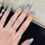 Dekorativer Stiletto Press-On Nagelset mit Stern- und Bogenakzenten Brehn