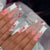Dekoratives Press-On-Nagelkunst-Set mit floralen und Schmuckakzenten Brehn 1788496044