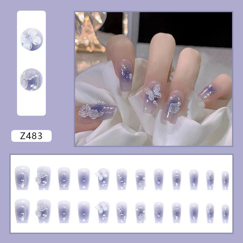 Kunstvolle Acryl-Nägel mit Schmetterlings-Design und Glitzerakzenten Brehn