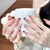 Künstlerisches Langes Stiletto Press-On Nagelset mit Schleife und Edelsteinakzenten Brehn