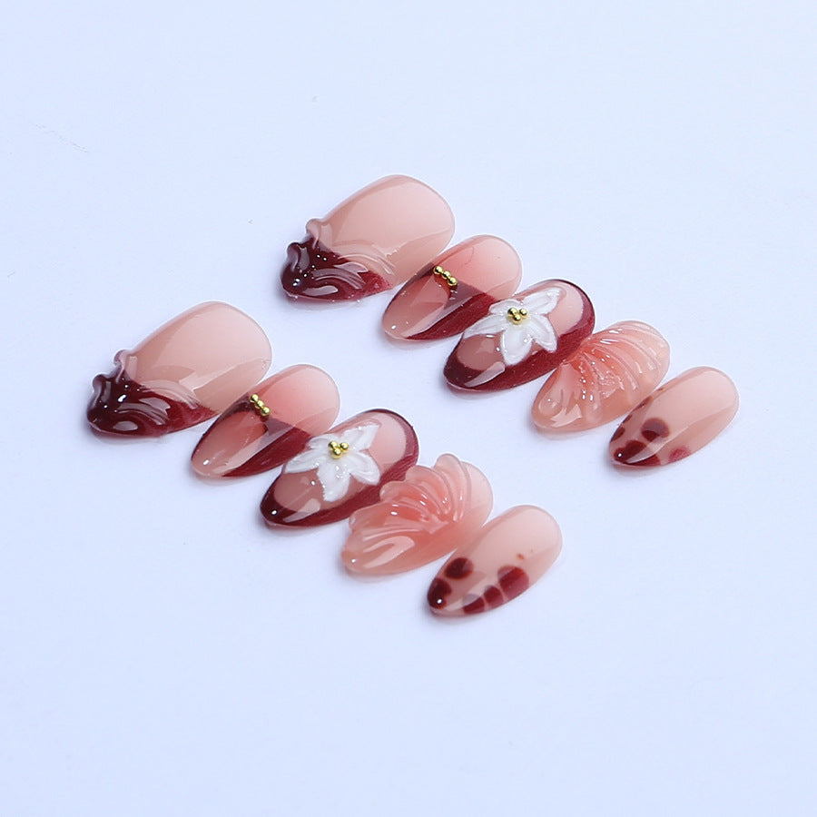 Kunstnagelset mit floralen 3D-Applikationen und eleganter Farbverlaufsgestaltung Brehn