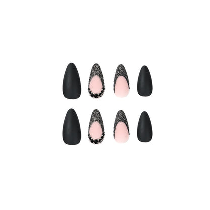 Kunstvolle Stiletto-Nägel mit elegantem Schwarz-Design und Glitzerakzenten Brehn