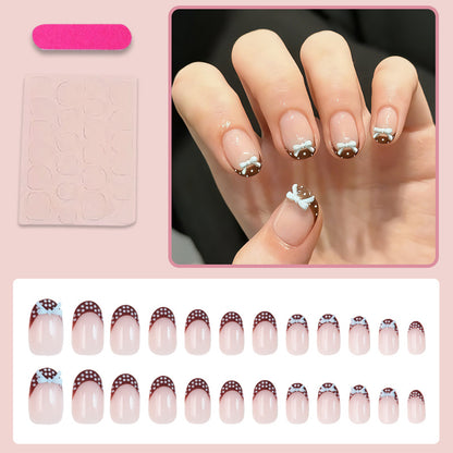 Kunstnagelset mit verspielten Schleifen und eleganten Punkten Brehn