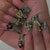 Künstlerisches Stiletto-Nageldesign mit floralen Akzenten und Edelsteinen Brehn