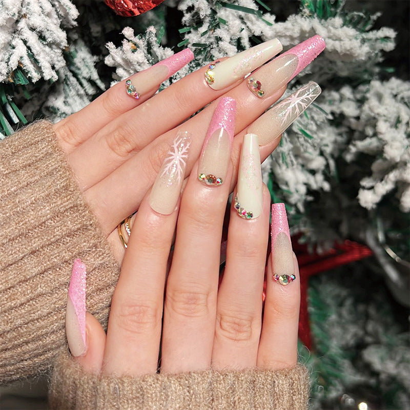 Kunstvolle Stiletto-Nägel mit Glitzer- und Schneeflockendesign Brehn