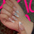 Kunstnagelset mit eleganten 3D-Blüten und glamourösen Akzenten Brehn
