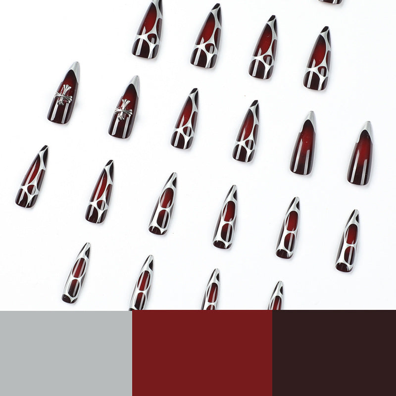 Kunstvolle Stiletto-Nägel mit eleganter Kreuzverzierung Brehn