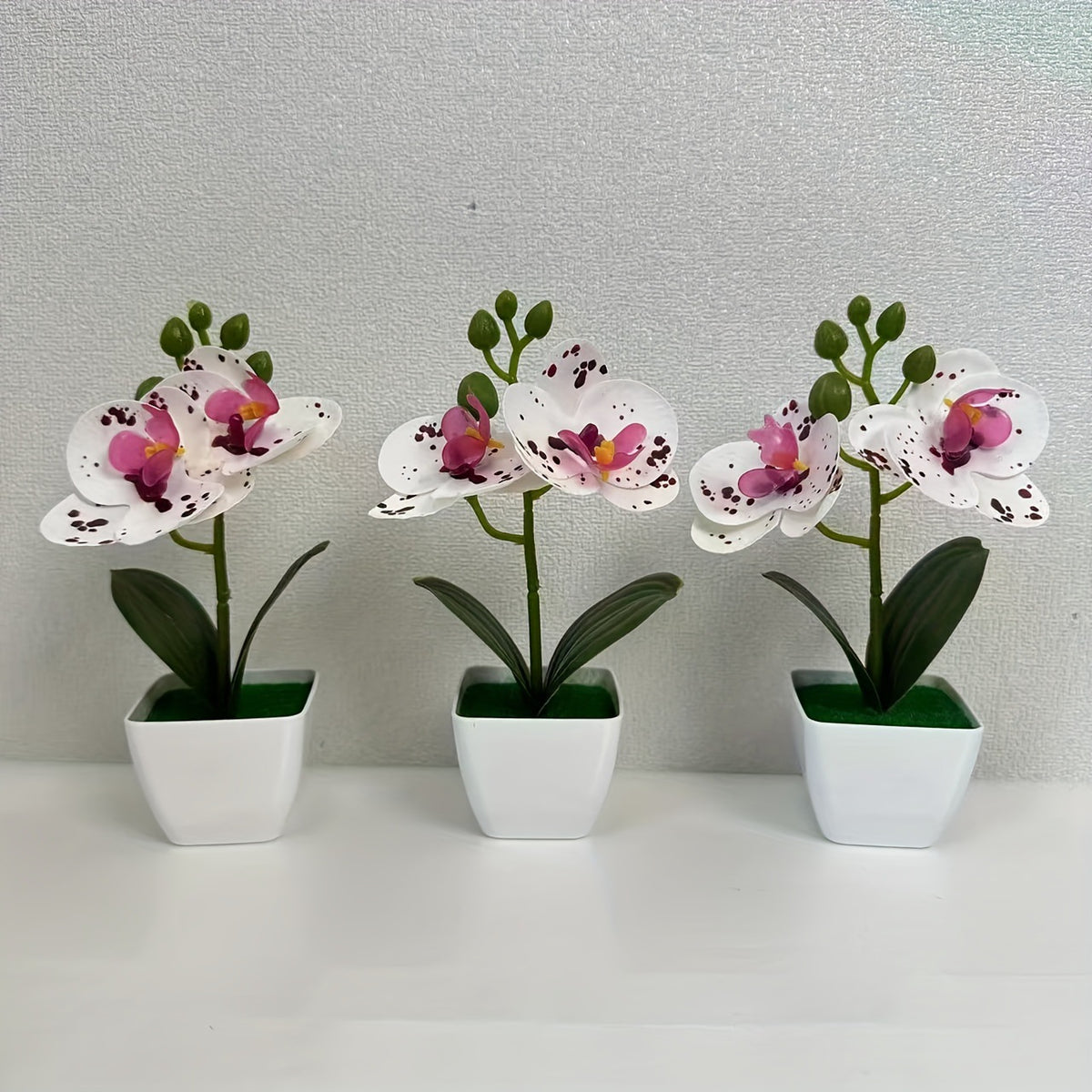 Dekorative künstliche Orchideenarrangement für die Wohnkultur展示