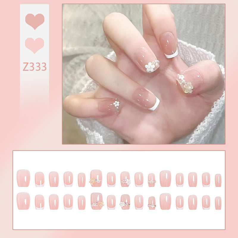 Kunstnagelset mit eleganten Blumenapplikationen und exquisite Glitzerverzierungen Brehn