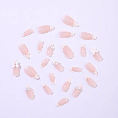 Kunstnagelset mit eleganten Perl- und Schleifenverzierungen Brehn
