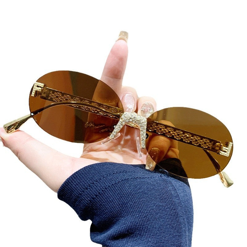 Damen Sonnenbrille mit glitzerndem Rahmen und ovalen Gläsern Brehn