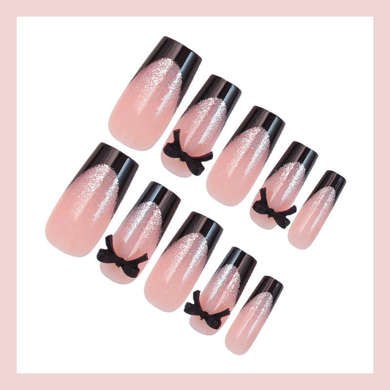 Kunstnagelset mit eleganten Glitzerakzenten und Schleifendetails Brehn