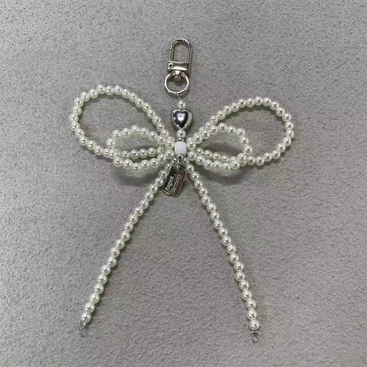 Elegante Perlenbogen Schlüsselanhänger Brehn