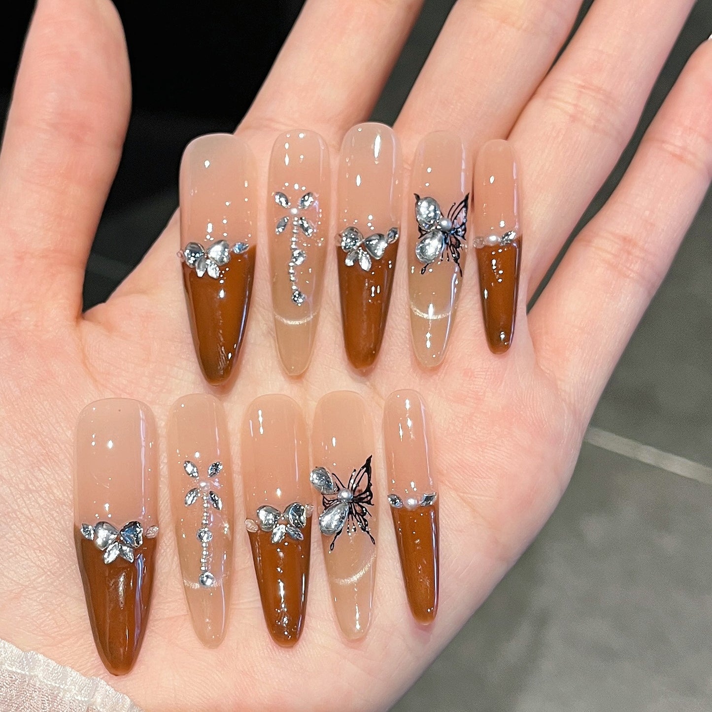 Künstlerische Stiletto Press-On Nagelkunst mit schimmernden Akzenten Brehn
