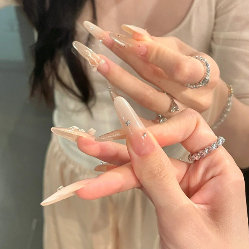 Elegante Stiletto Press-On Nägel mit dekorativem Bogen und Strassakzenten Brehn