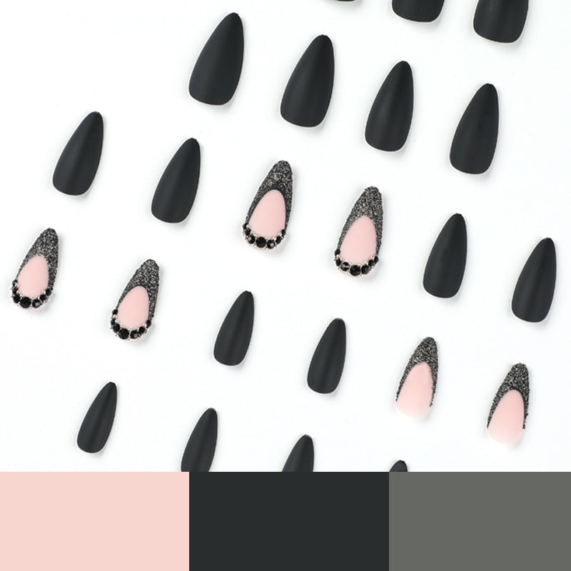 Kunstvolle Stiletto-Nägel mit elegantem Schwarz-Design und Glitzerakzenten Brehn