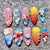 Kunstnagelset mit floralen Designs und glitzernden Akzenten Brehn