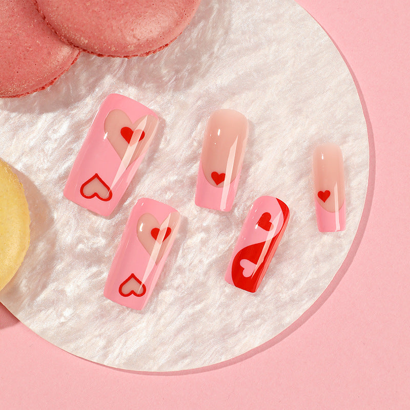 Künstliche Nagelkunst mit Herz-Design und Glitzerakzenten Brehn