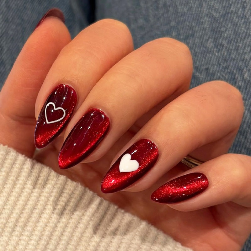 Glamouröses Kunstnagelset mit Glitzer-Effekten und eleganten Bogenmotiven Brehn