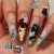 Kreatives Kunstnagelset mit bunten floralen und eleganten Designs Brehn