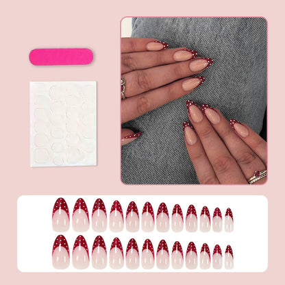Kunstnagelset mit eleganten roten Spitzen und verspielten Punkten Brehn