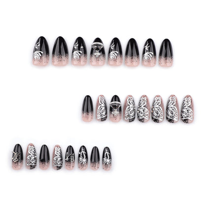 Kunstvolle Stiletto-Nägel mit filigranen Verzierungen und Glamour-Akzenten Brehn