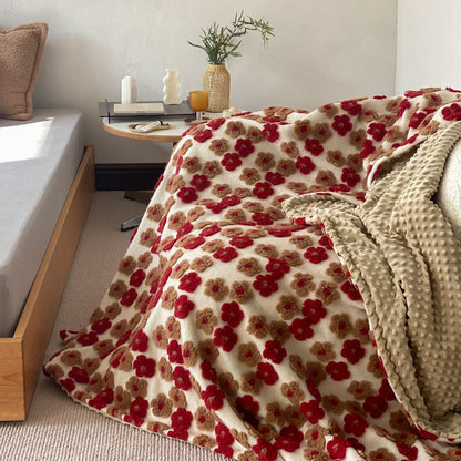 Gemusterte Wohndecke mit gewebten Blumenapplikationen