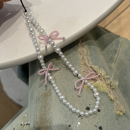 Dekorative Perlenbeaded-Halskette mit Schleifenakzenten Brehn