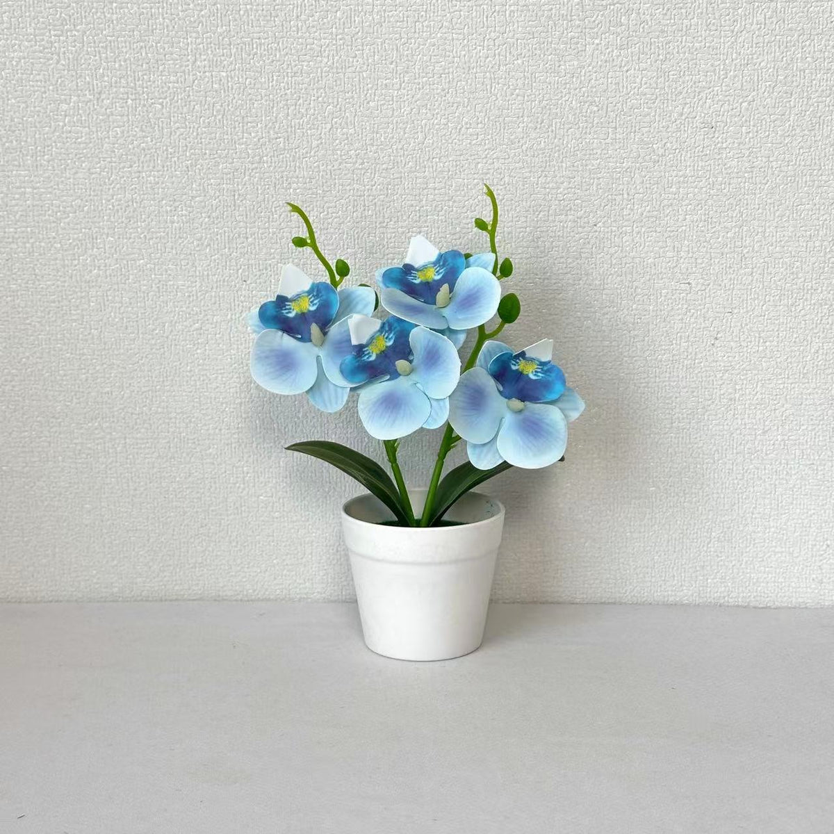 Elegante dekorative Orchideen-Blumenarrangement für die Wohnungseinrichtung