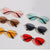 Damen geometrische Sonnenbrille mit rotem Glas und elegantem Metallrahmen Brehn
