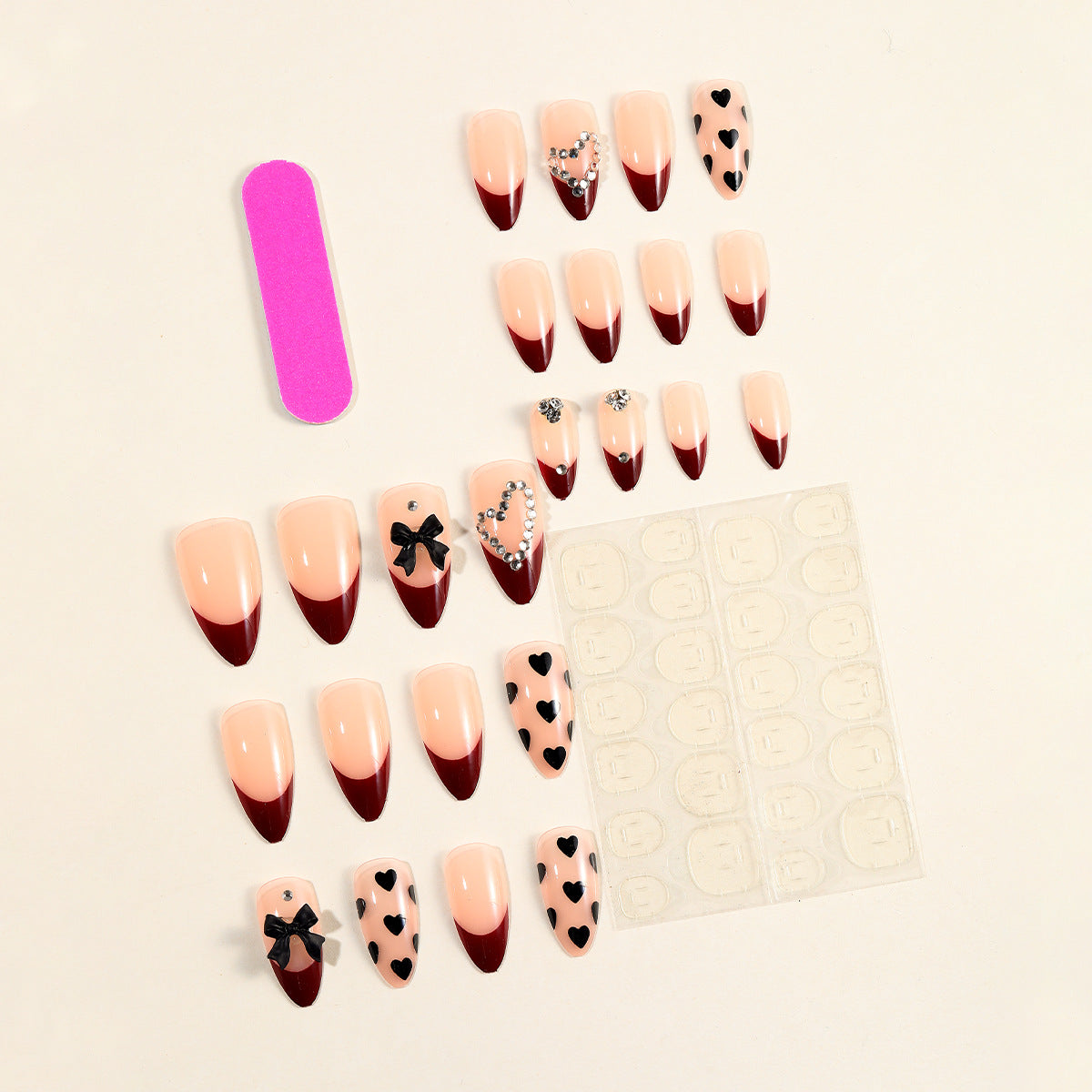 Künstlerische Stiletto-Nagelverlängerungen mit Herz- und Schleifenakzenten Brehn