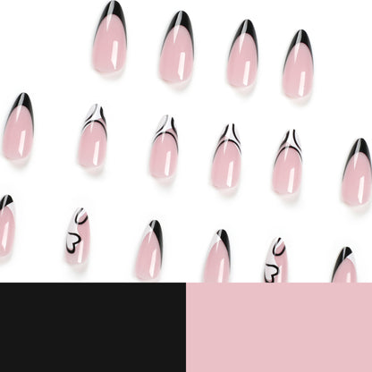 Kunstvolle Stiletto-Nägel mit elegantem Schwarz-Weiß-Design Brehn