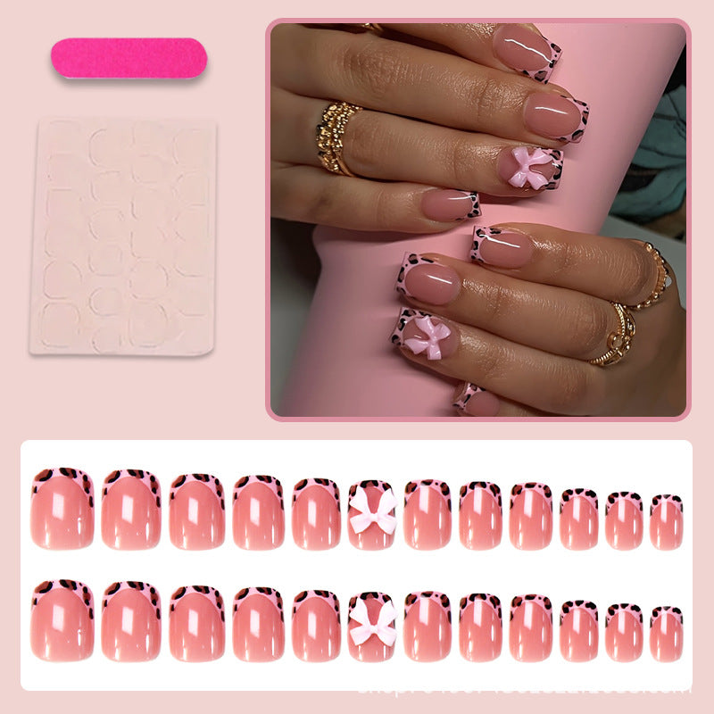 Kunstnagelset mit verspieltem Schleifen-Design und lebendigem Tierakzent Brehn