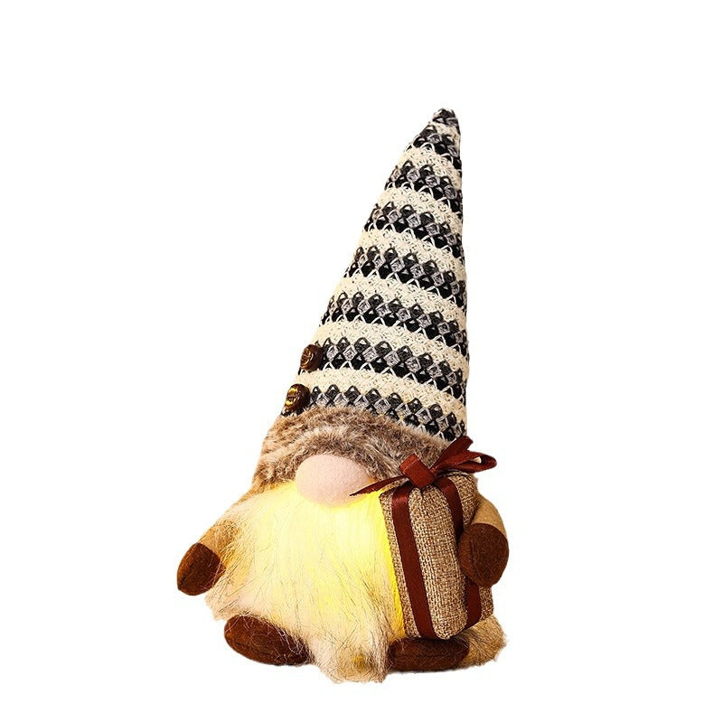 Dekorativer Weihnachtsgnom mit Geschenkpäckchen Brehn