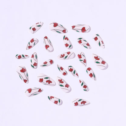 Kunstnagelset mit floralen Akzenten und Glitzer Brehn