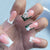 Kunstnagelset mit eleganten Strassverzierungen und floralem Design Brehn