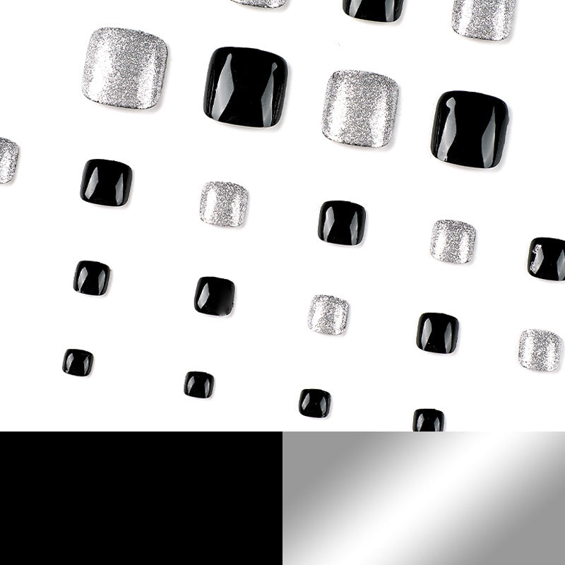 Kunstvolle Fußnagelkunst mit Glitzer- und Schwarzdesign Brehn