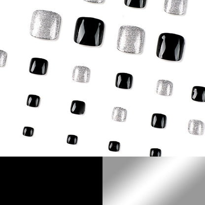 Kunstvolle Fußnagelkunst mit Glitzer- und Schwarzdesign Brehn