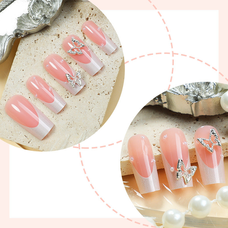 Kunstnagelset mit filigranen Designs und Schmetterlingsapplikationen Brehn