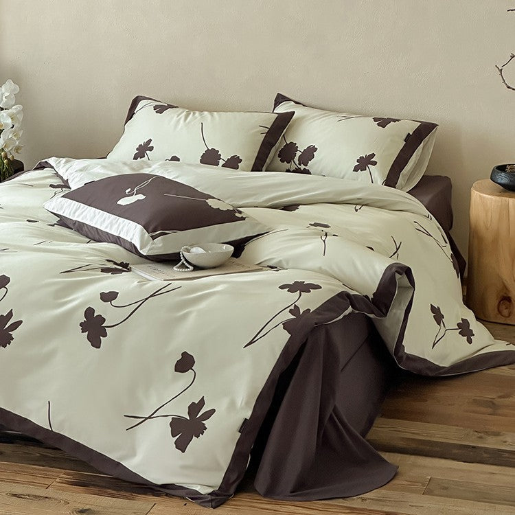 Wendbare Baumwollsatin-Bettwäschegarnitur mit floralem Silhouetten-Print und kontrastierender Kederkante