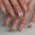 Künstlerisches Press-On-Nagel-Set mit charmanten Leopard- und Schleifenddesigns Brehn